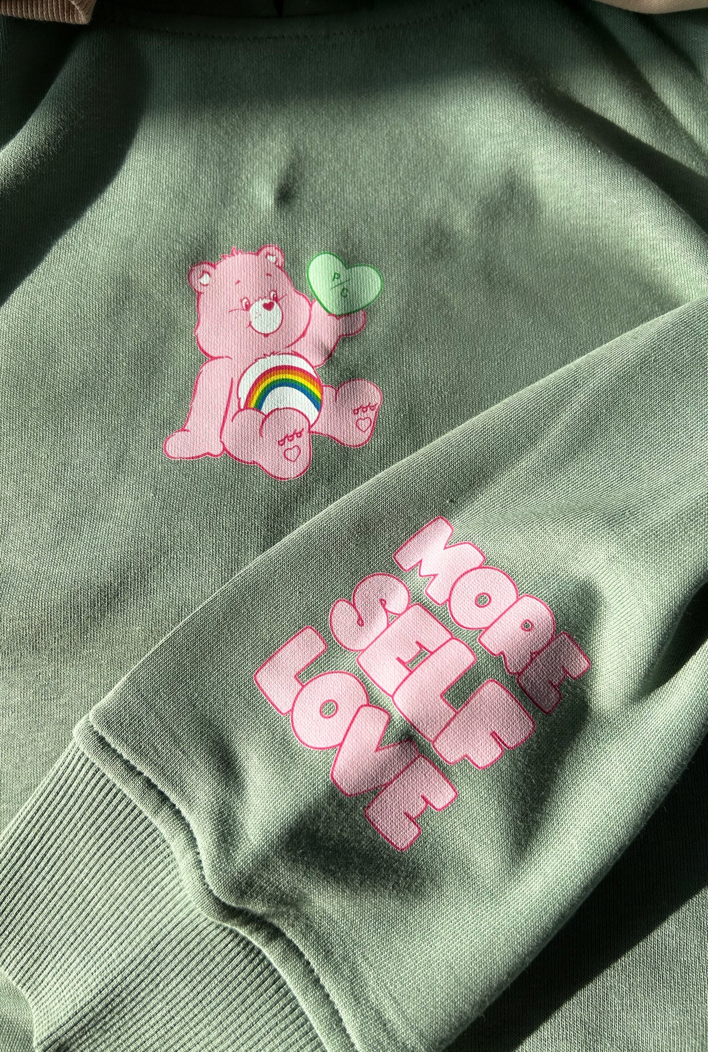 Cheer Bear More Self Love Hoodie - Sage